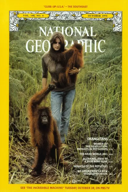 Žena s orangutany v divočině na obálce časopisu.